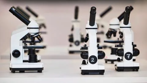 Many white microscopes lining up ready for scientific study and laboratory Stock Photos