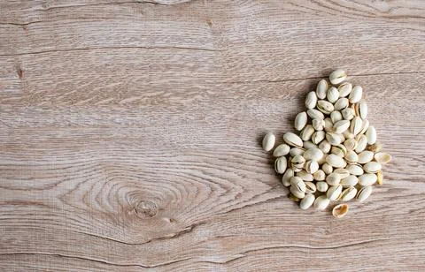 Many white nuts on a right old wood grain table corner and take a closeup a.. Stock Photos