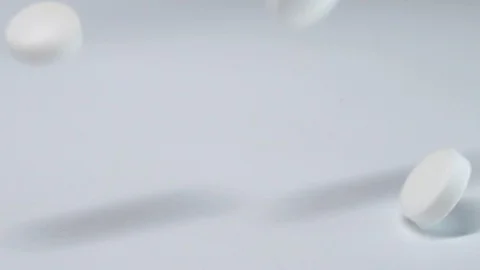Many white pills falling white background.Macro Stock Footage 127621794