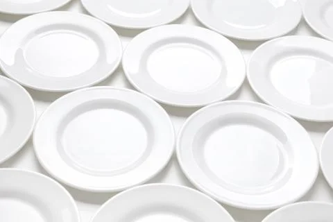 Many white plates on table, pattern of dishes Stock Photos