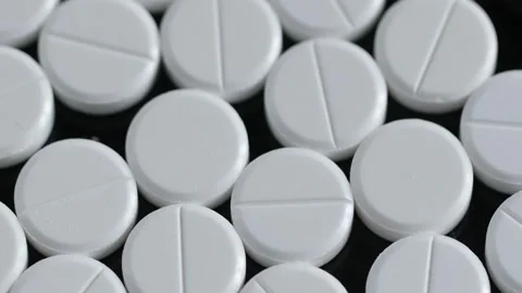 Many white round pills. Pharmaceutical production. Drugs on the production line Stock Footage 172359203
