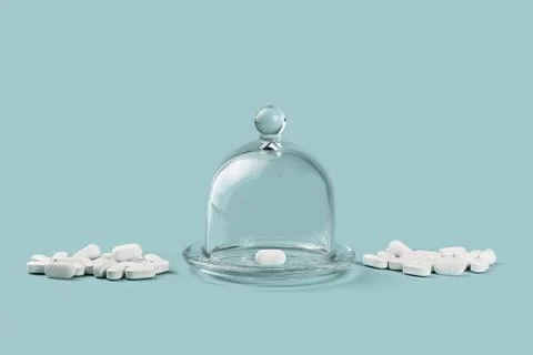 Many white tablets and one in glass dome container Stock Photos