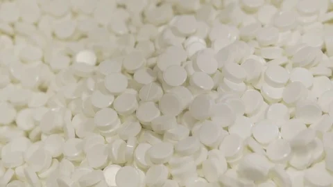 Many white tablets are scattered, drug manufacturing Stock Footage 72643298