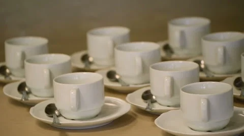 Many White Tea Cups in Table Stock Footage 58356833