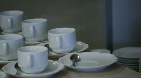 Many White Tea Cups in Table Stock Footage 58356868