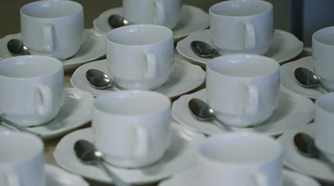 Many White Tea Cups in Table Stock Footage 58356889