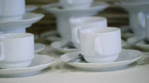 Many White Tea Cups in Table Stock Footage 58356958