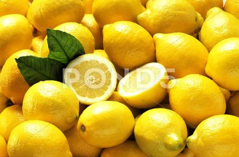 Many Whole Lemons with One Halved (Full Frame) Stock Photos