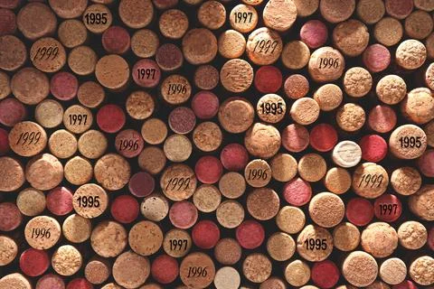Many wine corks with different dates as background, top view 写真素材
