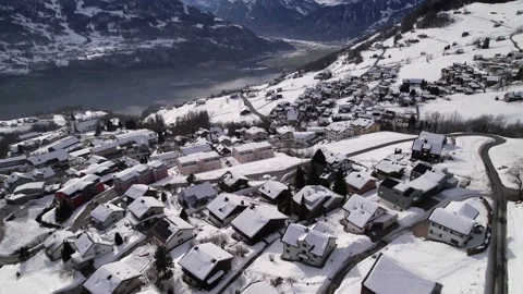 Many winter chalets on a snowy winter village in Switzerland, aerial forward Stock Footage 167468849