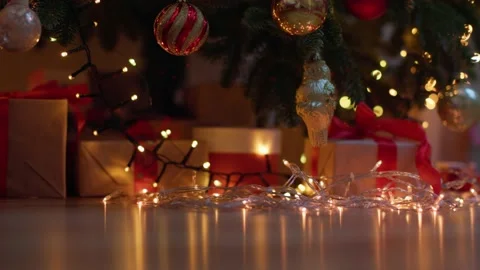 Many wrapped gift boxes alarm clock midnight time under christmas decorated tree Video stock 222825218