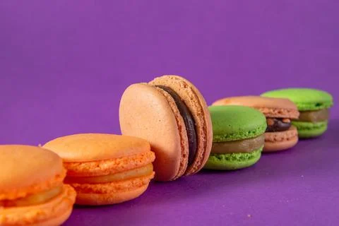 Many yellow,  beige green macaroon on a lilac Stock Photos