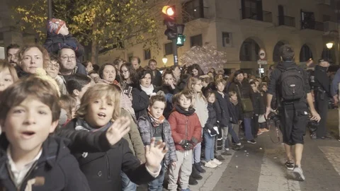 Many young children waving to camera behind metal barrier Stock Footage 101718830