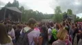 Many young people covered in colorful paint hang out at music fest, slow motion HD Footage
