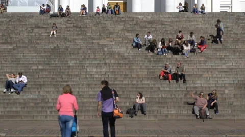 Many young people sit on the steps in front of the Cathedral in Helsinki. Stock Footage 67458226