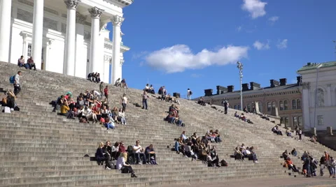 Many young people sit on the steps in front of the Cathedral in Helsinki. Stock Footage 67469924