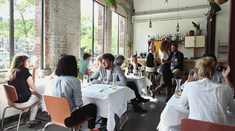 Many Young People Talking in Bright Stylish Restaurant Stock Footage