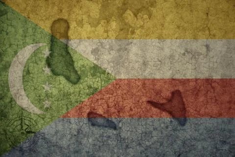 Map and flag of comoros on a old vintage crack paper background . Stock Photos