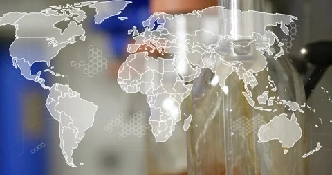 Map appearing leading nozzle descending, amber fluid dropping into flask linking Stock Footage 310669342