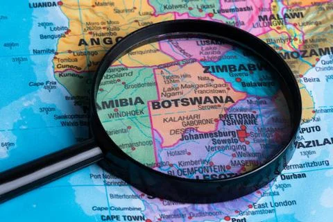 Map of Botswana through magnifying glass.Close-up. Stock Photos