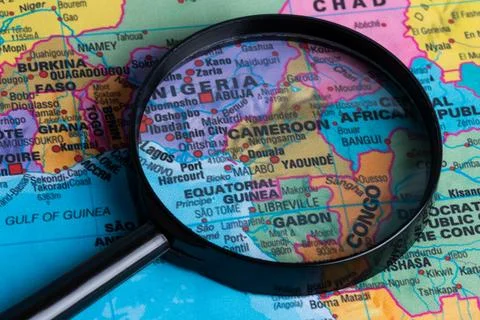 Map of Cameron through magnifying glass.Close-up. Stock Photos