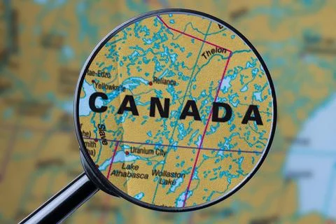 Map of CANADA through magnifying glass. Stock Photos