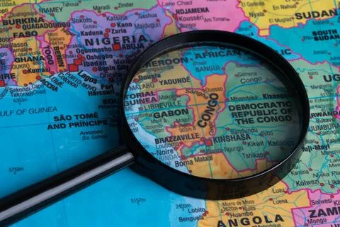 Map of Congo through magnifying glass.Close-up. Stock Photos