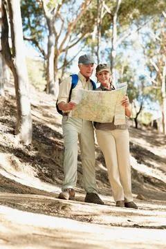 Map, hiking and reading with old couple in nature for trekking, fitness and Stock Photos