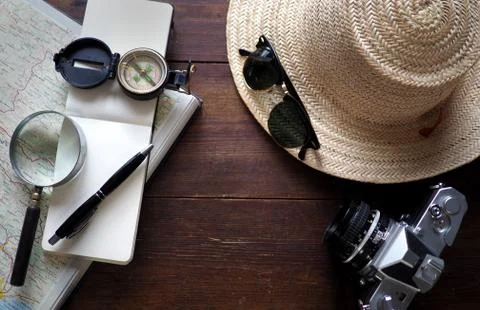 Map, notebook, camera and travel hat Фото