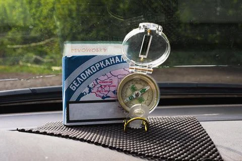 A map on a pack of cigarettes and a compass in the car for navigation Stock Photos
