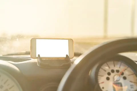 The map on the phone in the background of the dashboard. Stock Photos