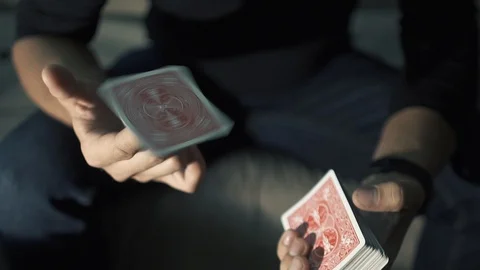 The map rotates on the finger. manipulation with a deck of cards. The magician Video stock 89445967