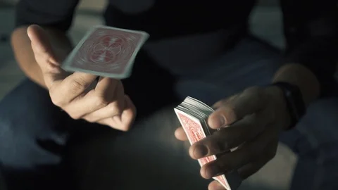 The map rotates on the finger. manipulation with a deck of cards. The magician Stock Footage 89446096