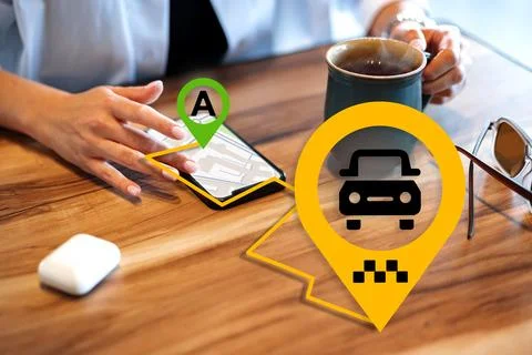 Map showing taxi location while a person holds a cup of coffee at a table Stock Photos