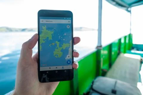 A map on the smartphone shows the destination Stock Photos