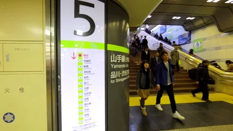 Map of the Tokyo subway branch, passengers walk on the background. Japan Stock Footage