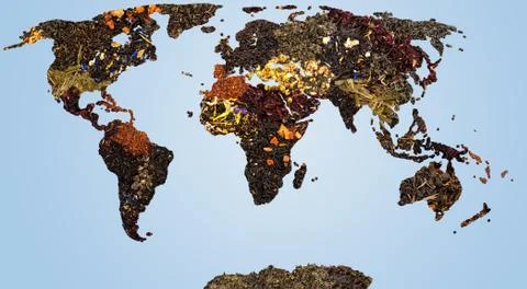 Map of world from different kind of dry tea herbs blue background Stock Photos