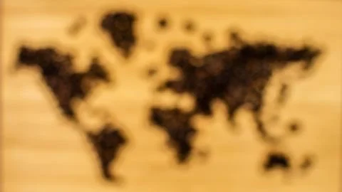 Map of the world made of coffee beans defocused Stock Photos