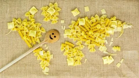 Map of the world made of raw pasta on fabric background Stock Photos