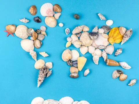 Map of the world made of shells on blue background Foto stock