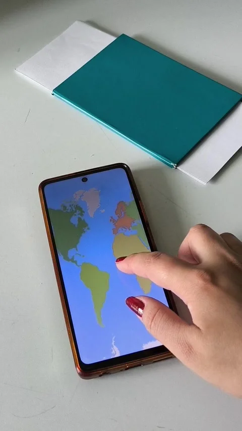A map of the world on the phone screen in the hands of a woman Stock Footage 334794774