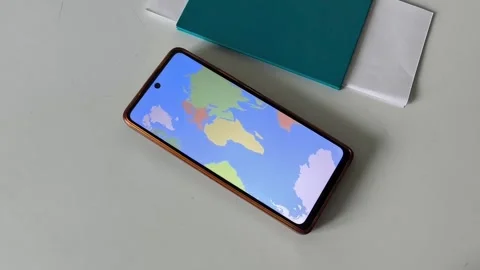 A map of the world on the phone screen on the table Stock Footage 334794946