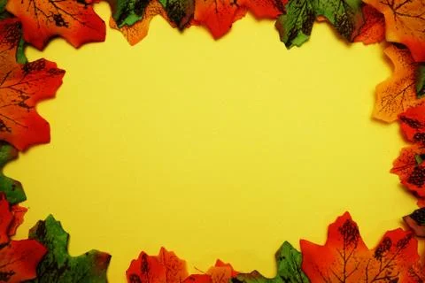 Maple autumn leaf border over on yellow background Stock Photos