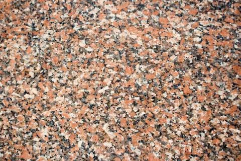 Maple leaf red granite stone background. Spotted red and black colored granite Foto stock