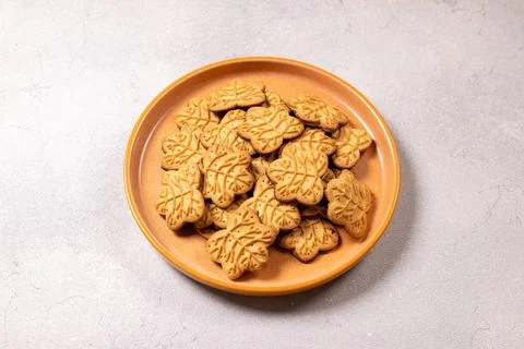 Maple leaf shaped cookies on orange plate Stock Photos