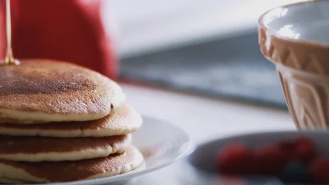 Maple Syrup Being Poured On Stack Of Freshly Made Pancakes Or Crepes On Table Stock Footage 124588431