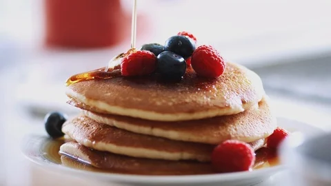 Maple Syrup Being Poured On Stack Of Freshly Made Pancakes Or Crepes On Table Stock Footage 124588575
