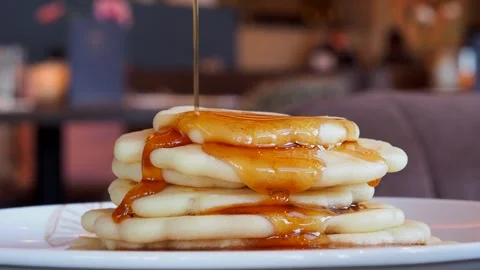 Maple Syrup Being Poured Onto A Stack Of Freshly Cooked Pancakes, UK Stock Footage 274440737