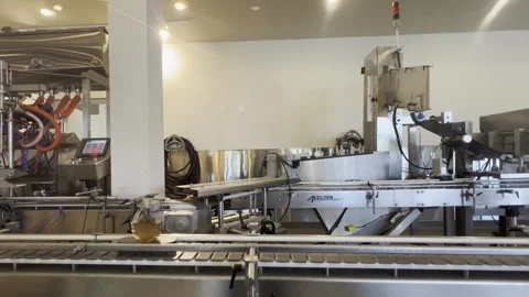 Maple syrup bottling line with automated conveyor system indoors, canada Stock Footage 302576512