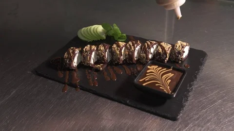 Maple syrup on chocolate sushi Stock Footage 71425453